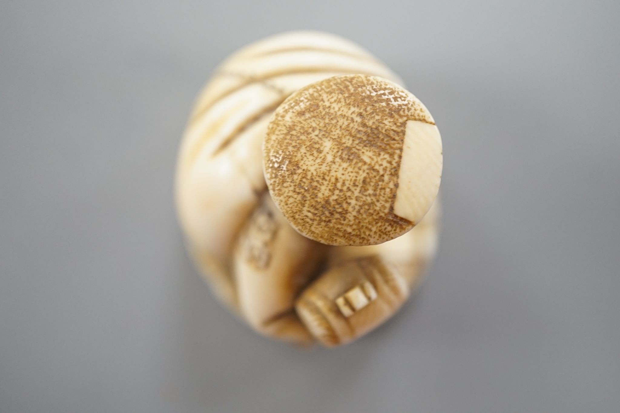 A Japanese ivory netsuke of Daikoku, Meiji period, 3 cms high.